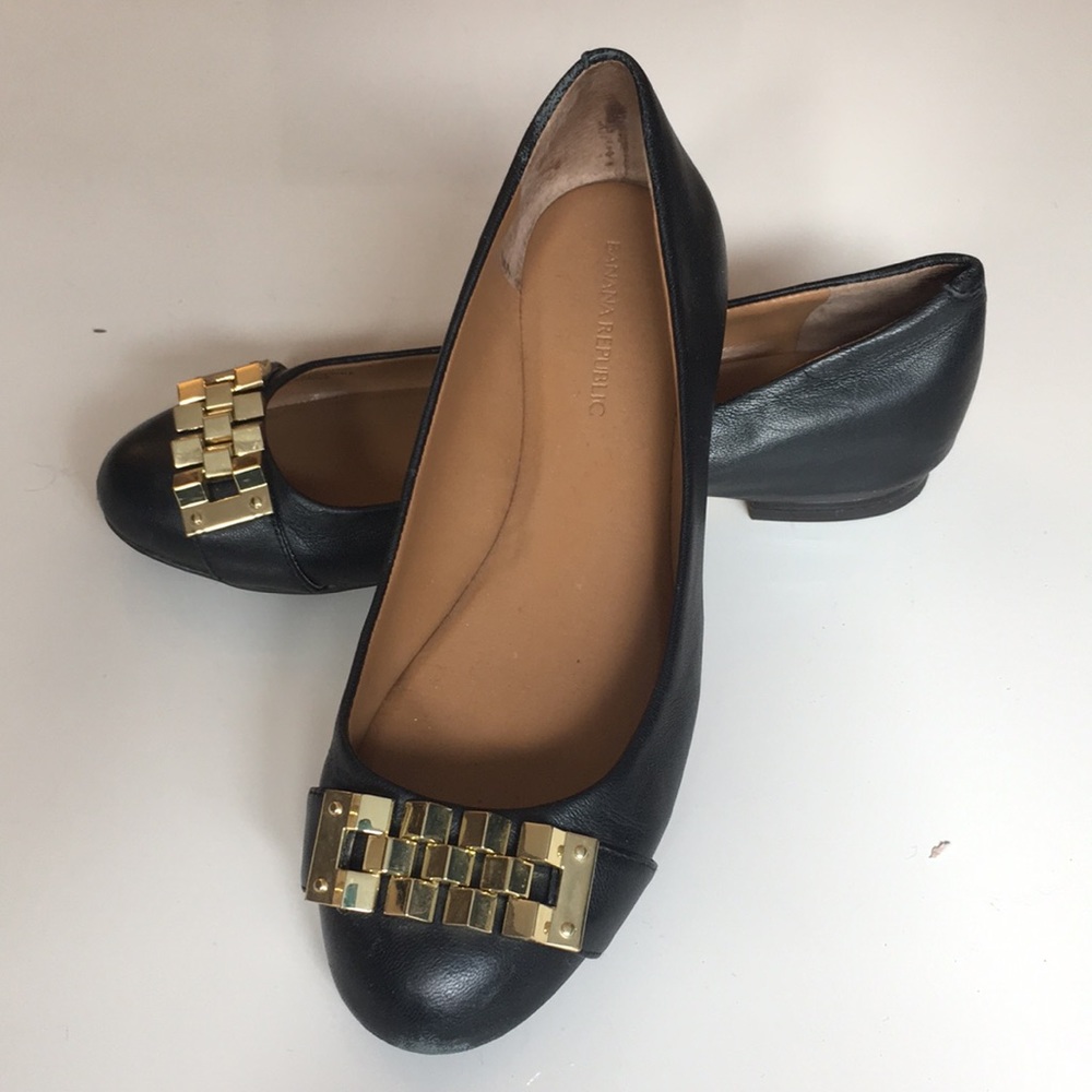 Black leather flats with gold metal detail